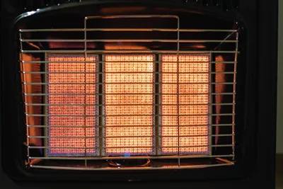 A portable gas heater glowing orange.